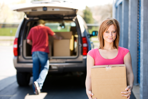 Storage:,woman,carrying,box,to,storage,unit